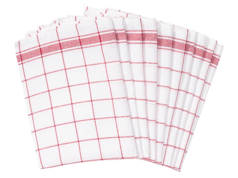 Une pile de torchons de cuisine blancs à carreaux rouges.