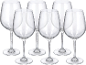 Six verres à vin transparents avec de longues tiges et de larges bols sur fond noir.