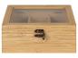 Une boîte à thé en bois avec un couvercle en verre et des compartiments pour différents types de thé.