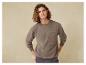 Un homme portant un sweat-shirt marron avec le logo LVG.