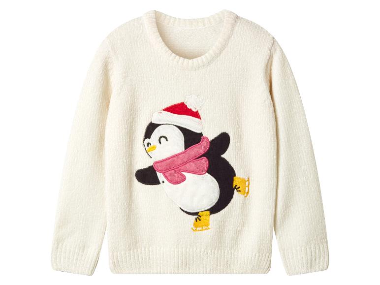 Pull blanc avec un pingouin patinant, portant un bonnet de Père Noël et une écharpe rose