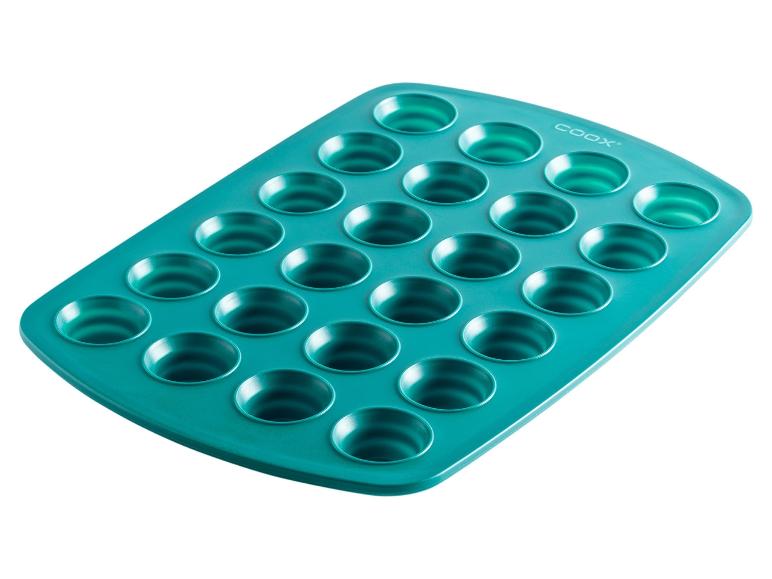 Un moule à muffins Coox turquoise avec 24 cavités.