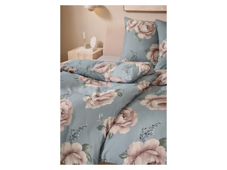 Drap-housse en jersey LIVARNO home sur un lit avec parure de lit fleurie