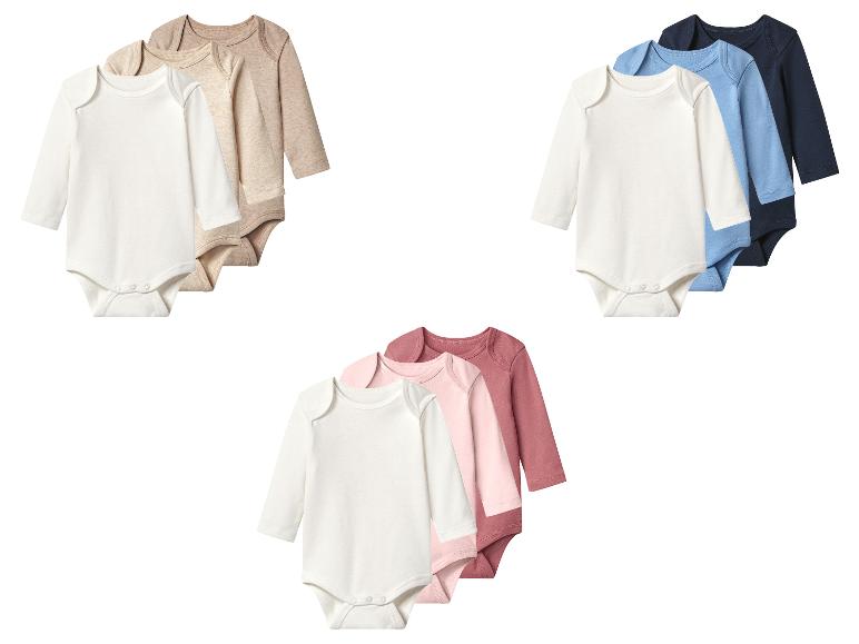 Lot de trois bodys bébé à manches longues en blanc, beige et marron clair.