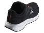 Chaussures de sport noires avec détails orange et semelle blanche, vue arrière.
