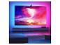 Grande télévision avec rétroéclairage ambiant affichant une scène spatiale vibrante dans un salon moderne.