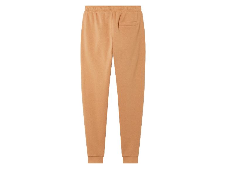 Pantalon de survêtement beige avec une taille élastique.