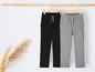 Pantalons de survêtement noirs et gris avec cordon de serrage.