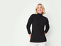 Une femme porte un pull noir à col roulé.