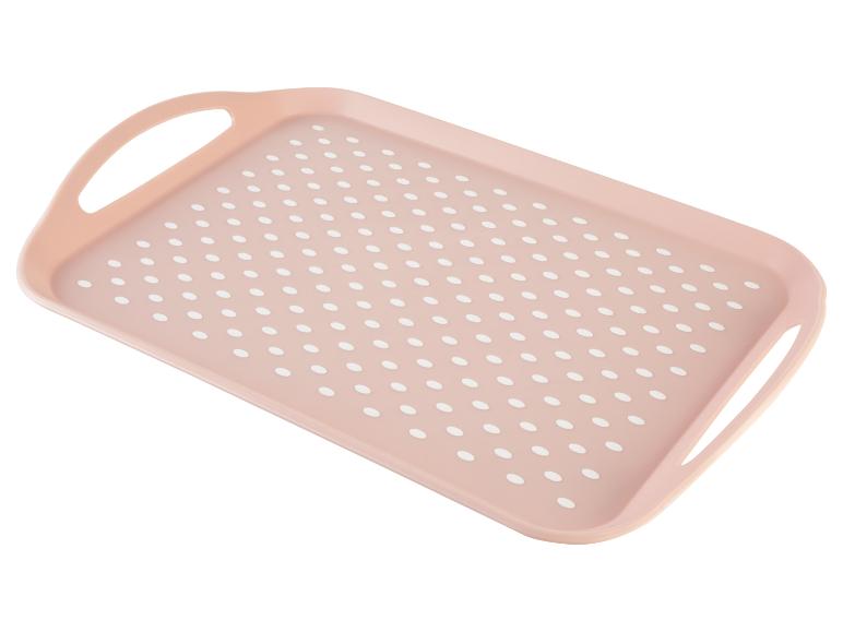 Plateau rose à pois blancs avec poignées.