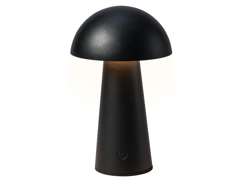 Lampe de table noire en forme de champignon avec interrupteur tactile, émettant une lumière chaude.