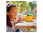 Une fille joue avec un set LEGO de fleurs et un papillon.