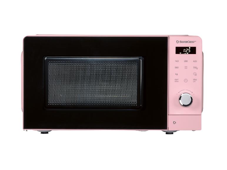 Micro-ondes rose avec une porte noire et un panneau de commande numérique.