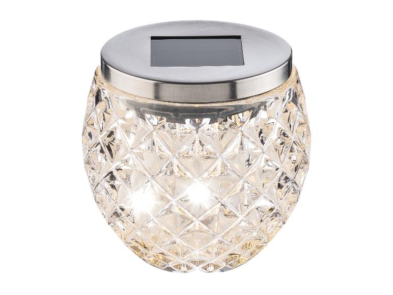 Lampe solaire de jardin en verre avec motif diamant et couvercle métallique.