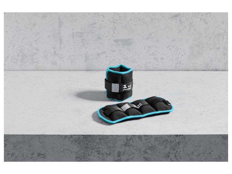 Deux poids de cheville noirs Crivit, l'un pesant 1 kg.