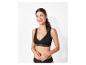 Une femme porte un soutien-gorge et une culotte noirs.