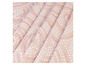 Tissu rose avec des points blancs et bruns.