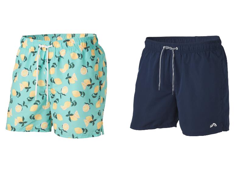 Deux shorts de bain pour hommes : un à imprimé citrons et un bleu foncé.