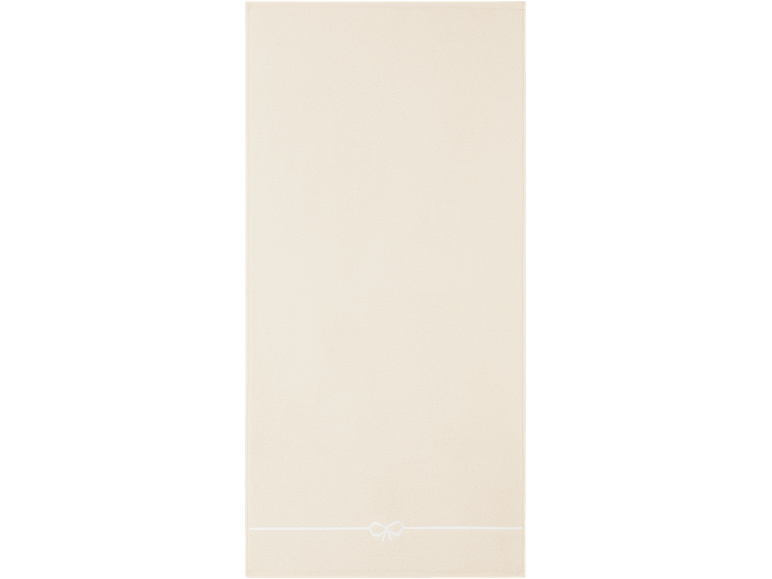 Serviette beige clair avec une bande blanche et un nœud en bas.