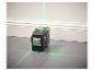 Un niveau laser vert Parkside projette des lignes sur un sol en carrelage.