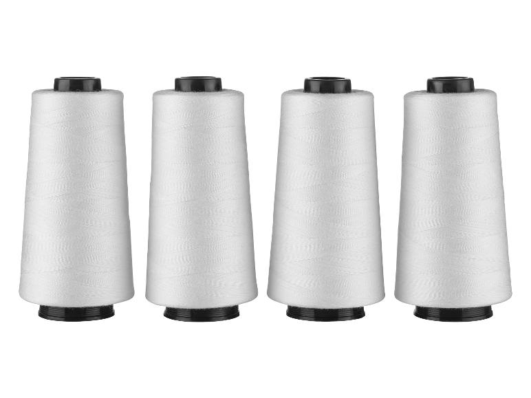 Quatre bobines de fil blanc.