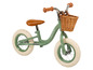 Une draisienne verte Huffy avec un panier en osier.