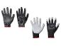 Deux paires de gants de travail Parkside, une noire et une noir et blanc, avec bordure rouge.