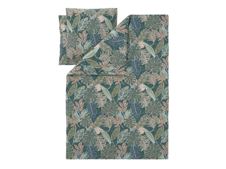 Parure de lit avec motif de feuilles tropicales dans des tons verts et bruns.