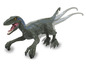 Un jouet dinosaure velociraptor vert et bleu avec des roues.