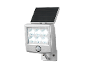 Lampe solaire LED argentée avec détecteur de mouvement, fixée au mur.