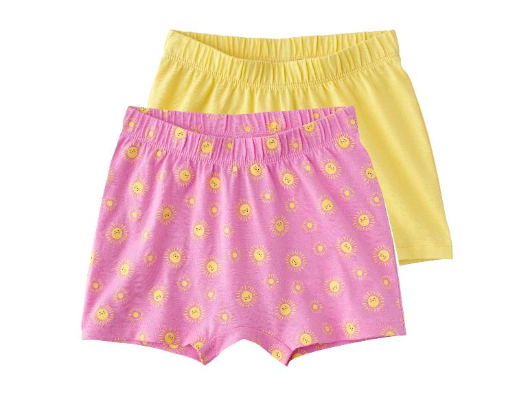 Deux shorts pour filles, un rose avec des soleils et un jaune.