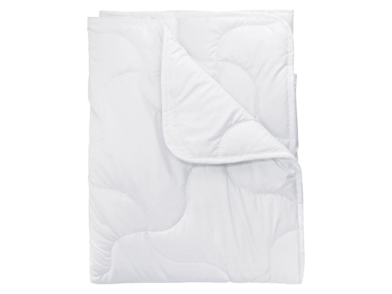 Une couette blanche matelassée, pliée.