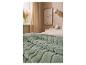 Doux plaid vert LIVARNO home posé sur un lit.