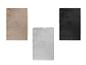 Trois tapis en beige, gris et noir avec un motif en losanges.