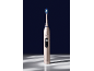 Brosse à dents électrique dorée à poils bleus, affichant 'Clean' et une icône de dent.