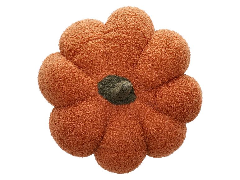 Coussin en peluche en forme de citrouille.