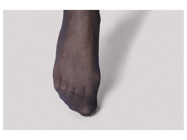 Gros plan sur un pied en collants noirs.