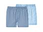 Deux boxers pour hommes : un uni bleu et un rayé bleu clair.