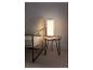 Lampe de table avec télécommande sur une table en bois à côté d'un fauteuil.