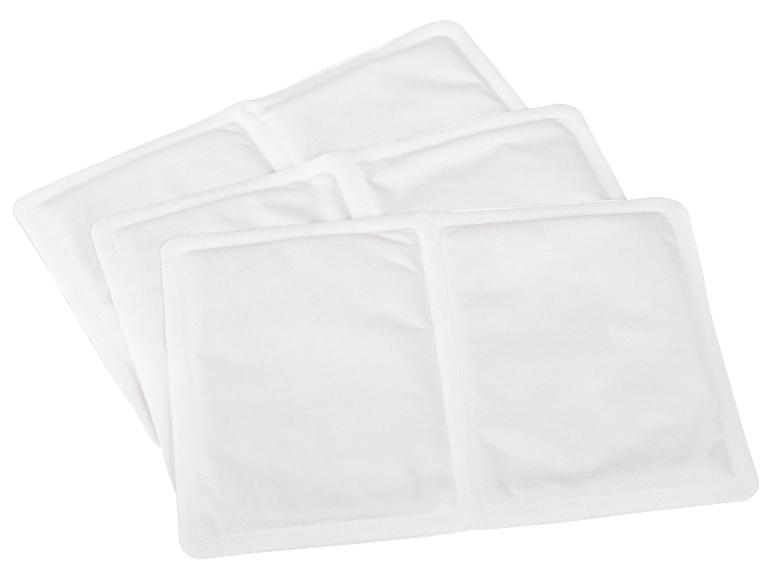 Trois coussinets chauffants blancs pour soulager la douleur.