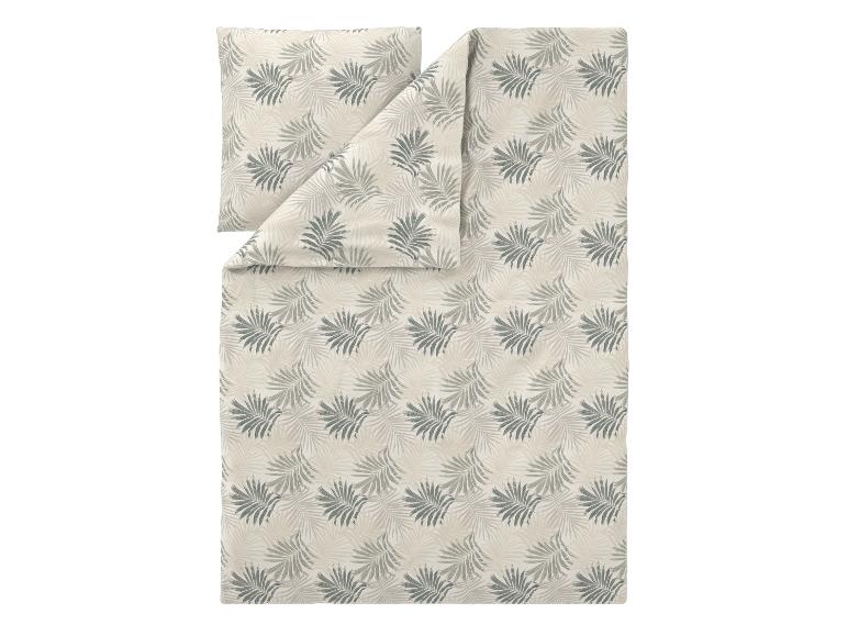 Parure de lit avec motif feuilles de palmier dans les tons beige et vert.