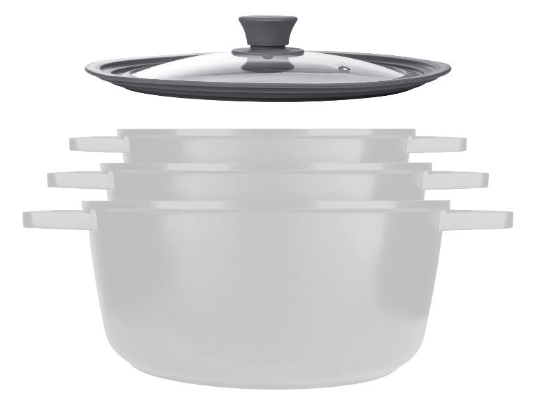 Un ensemble de trois casseroles blanches avec un couvercle en verre.