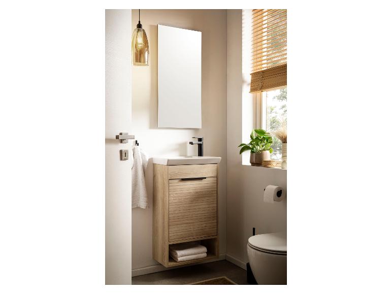 Salle de bain moderne avec meuble-lavabo en bois, miroir et toilettes.