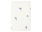 Drap-housse blanc pour lit bébé avec imprimé palmiers bleus.