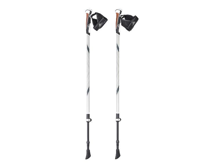 Une paire de bâtons de randonnée blancs et noirs avec des poignées en liège marron et des dragonnes noires.