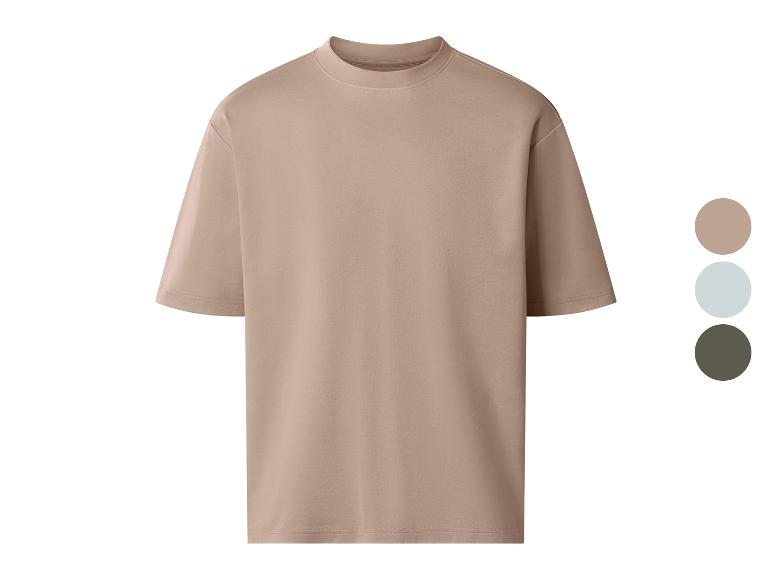T-shirt oversize beige à col rond, disponible en trois couleurs.