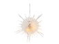 Étoile en papier blanc suspendue avec lumière chaude sur fond noir