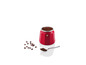 Une cafetière rouge avec du café moulu et des grains de café.