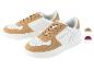 Des baskets U.S. Grand Polo blanches et marron.
