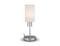 Une lampe de table argentée avec un abat-jour rond blanc.